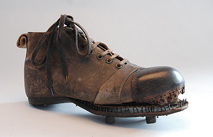 Early football boot with nailed sole and protective cap (about 1890).